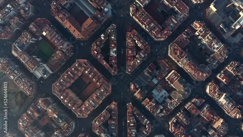 Top down footage of symmetrical town development. Fly above blocks of buildings in urban borough. Barcelona, Spain