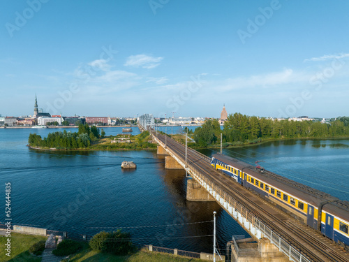 Train crossing river Daugava in Riga, Latvia. Beautiful aerial view of Riga.