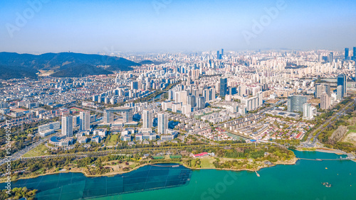 Aerial photography of Bogong Island Ecological Park, Yuantouzhu Scenic Area and the city center building complex in Wuxi City, Jiangsu Province, China photo