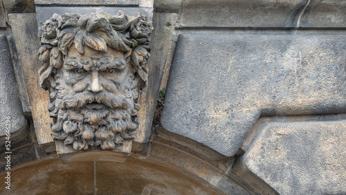 Valokuva Old relief bar, a keystone in a building arch, of an old bearded man face in the historical downtown of Dresden, Germany, details, with copy space