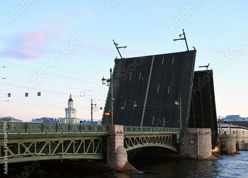 Palace Bridge, road- and foot-traffic bascule bridge, spans Neva River against backdrop of the Kunstkamera building (Museum of Anthropology and Ethnography) in Saint Petersburg at white night