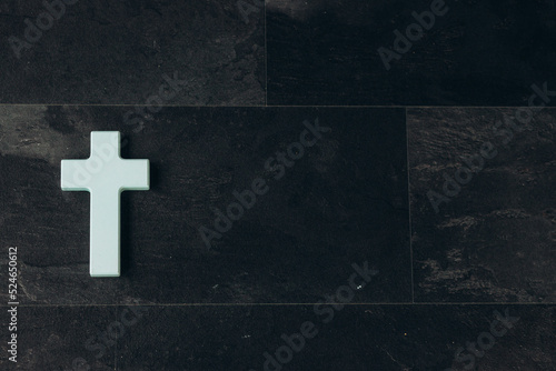 Valokuvatapetti Christian cross on a textured black background