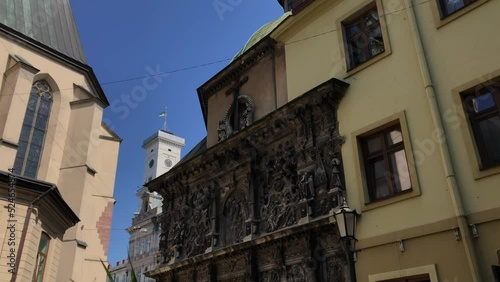 Boim Chapel outside in far away Ratusha with flag of Ukraine. UNESCO World Heritage Site In Lviv, Ukraine. photo