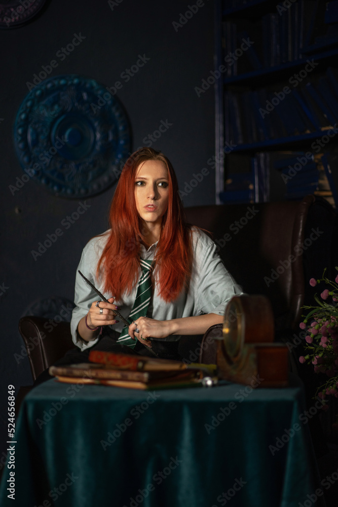 A young red-haired witch with a magic wand and a haughty expression sitting in an old library, witchcraft books and old clock on the table. She is dressed in a white shirt, black skirt and green tie A young red-haired witch with a magic wand and a haughty expression sitting in an old library, witchcraft books and old clock on the table. She is dressed in a white shirt, black skirt and green tie