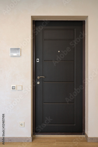 Black front door in the hallway of the apartment