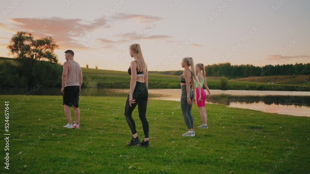 young sexy women are training with professional fitness coach in park area in evening, rear view, ideal female figure young sexy women are training with professional fitness coach in park area in evening, rear view, ideal female figure