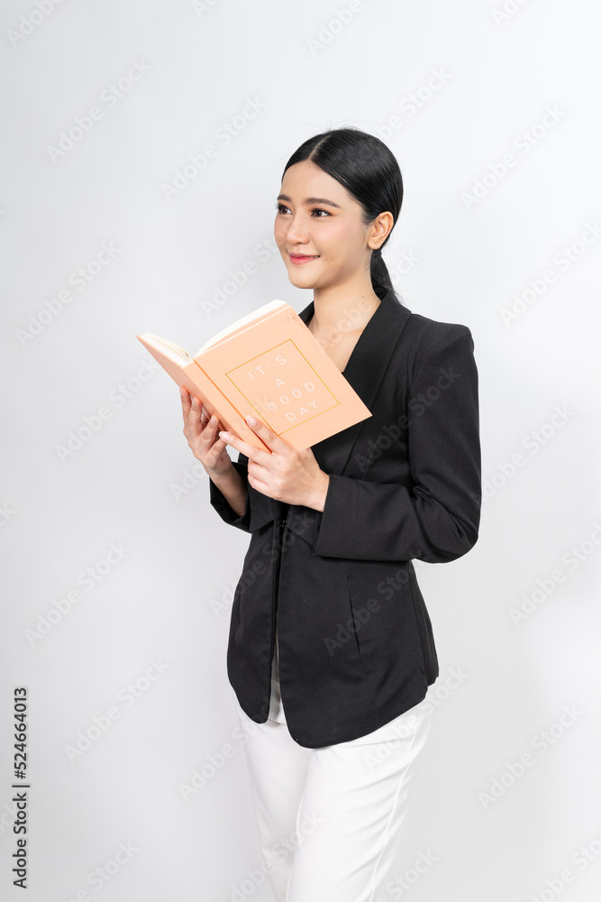 Portrait photo of a young beautiful and elegant asian woman holding a note book with a good nice friendly smile and different poses and emotion Portrait photo of a young beautiful and elegant asian woman holding a note book with a good nice friendly smile and different poses and emotion