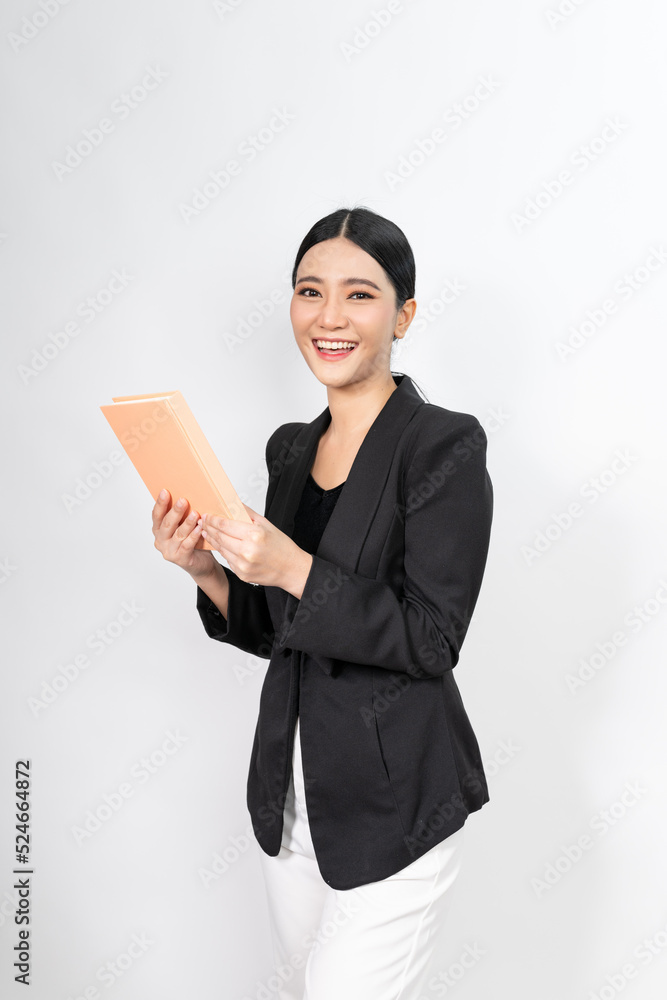 Portrait photo of a young beautiful and elegant asian woman holding a note book with a good nice friendly smile and different poses and emotion Portrait photo of a young beautiful and elegant asian woman holding a note book with a good nice friendly smile and different poses and emotion