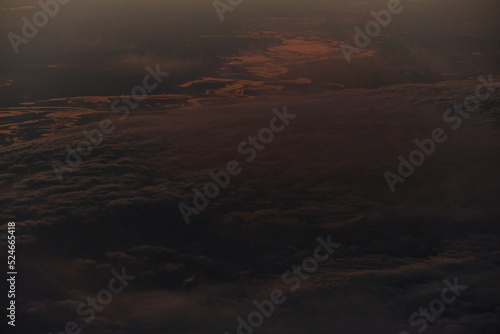 clouds photographed from the window curtain of an airplane