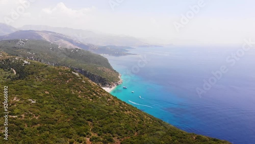 Aerial Drone View of Gjipe Beach and Canyon, Dhermi, Albania - Hidden Paraside with boats, tourists, sunbeds and blue sea photo