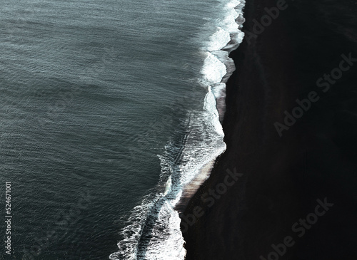 Print op canvas View of black sand beach Atlantic ocean waves in Iceland.