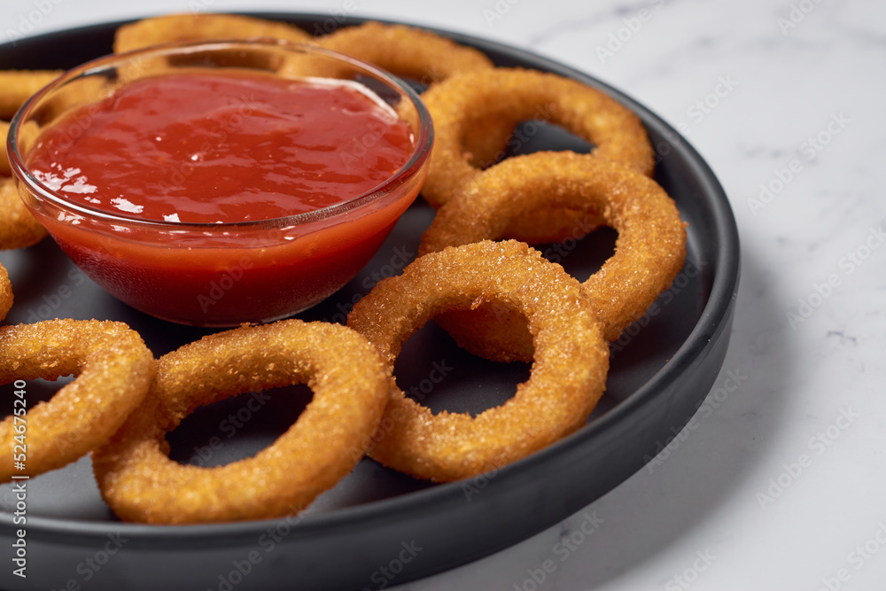 Homemade crunchy fried onion rings with tomato sauce Homemade crunchy fried onion rings with tomato sauce