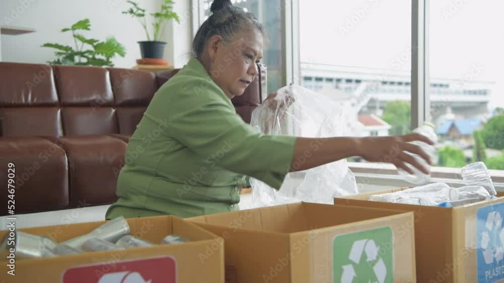 Nature conservation concept of 4k Resolution. Asian elderly woman sorting garbage in the house. Nature conservation concept of 4k Resolution. Asian elderly woman sorting garbage in the house.