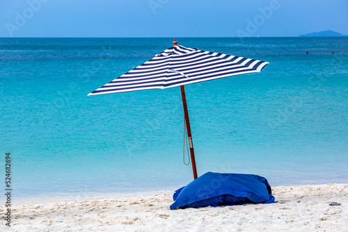 beach and umbrella in the tropical beachBeach umbrellas on the beach of the Tropical sea