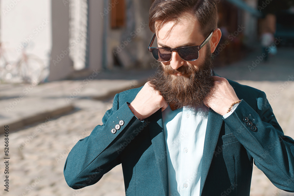 Stylish man with beard wearing a jacket, shirt and bow tie