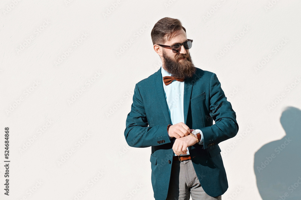 Stylish man with beard wearing a jacket, shirt and bow tie