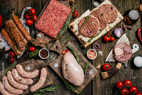 Raw meat products, different parts of the body. minced beef meat kebabs, pork, beef, chicken on a wooden background. banner, menu, recipe place for text, top view
