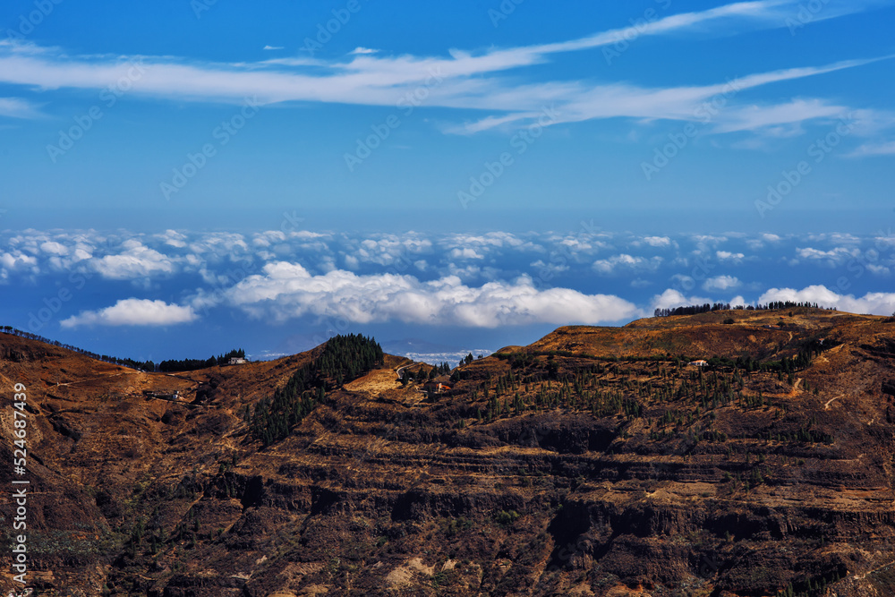 Mountain landscape panorama view on the island Gran Canaria - with sky on the background - picturesque hiking route higher than clouds