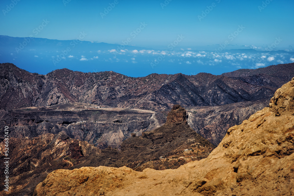 Mountain landscape panorama on the island Gran Canaria with ocean and sky on the background - breathtaking view higher than clouds