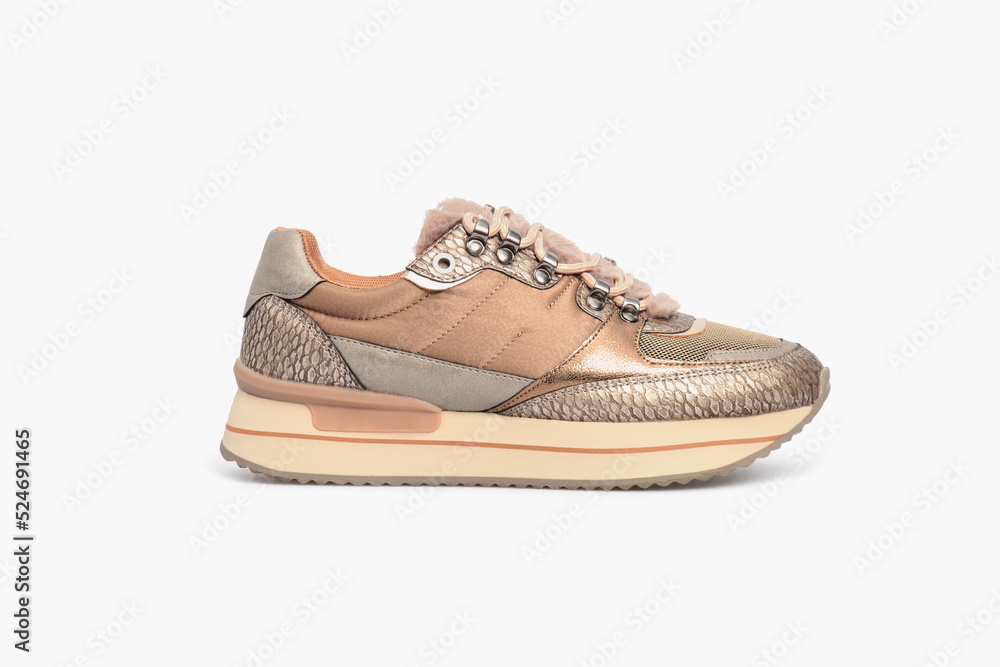 Classic fashion leather women's beige nude golden snakeskin sneakers shoe isolated on white background. Side view, template, mock up Classic fashion leather women's beige nude golden snakeskin sneakers shoe isolated on white background. Side view, template, mock up