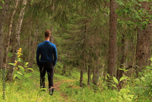 Man with blue sweater standing in a forest. Summer day. Jämtland, Sweden, Europe © Martin of Sweden