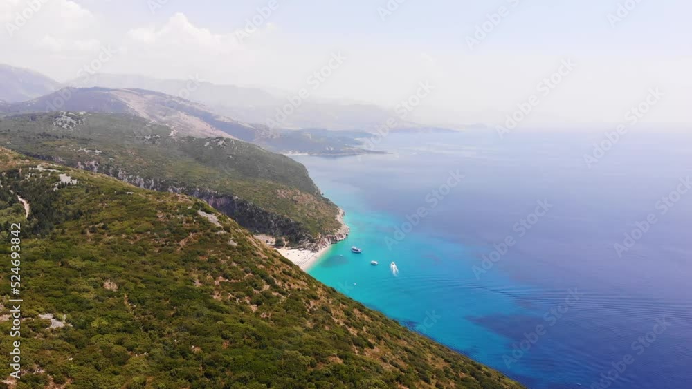 Aerial Drone View of Gjipe Beach and Canyon, Dhermi, Albania - Hidden Paraside with boats, tourists, sunbeds and blue sea Aerial Drone View of Gjipe Beach and Canyon, Dhermi, Albania - Hidden Paraside with boats, tourists, sunbeds and blue sea