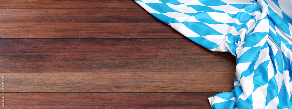 Obraz premium Oktoberfest background. Bavarian blue and white color flag on wood, banner.