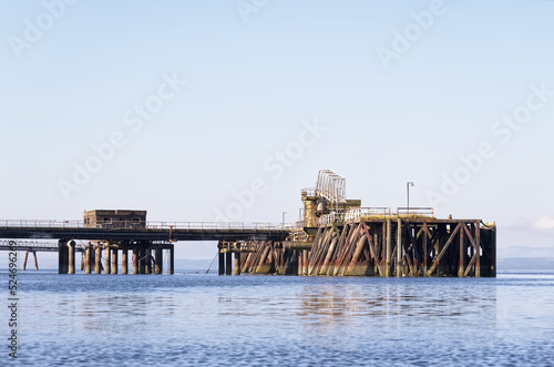 Old derelict wooden jetty pier in sea at Inverkip power station photo