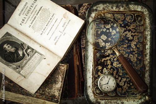 old book with antique clock