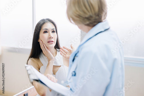 Beautiful Asian woman consulting a cosmetologist for cosmetic surgery in a clinic.