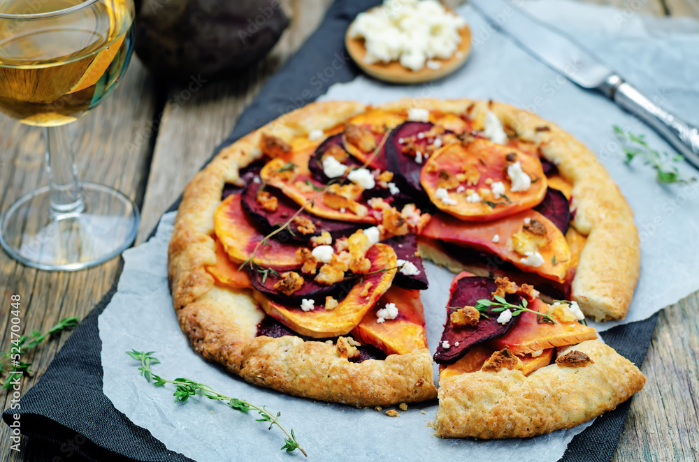 Sweet potato beets galette with goat cheese and thyme on a wood background Sweet potato beets galette with goat cheese and thyme on a wood background