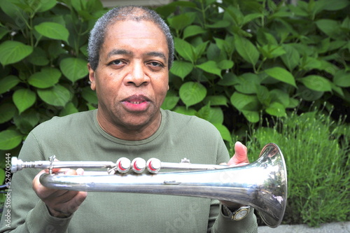 African american jazz musician with his flugelhorn outdoors. photo