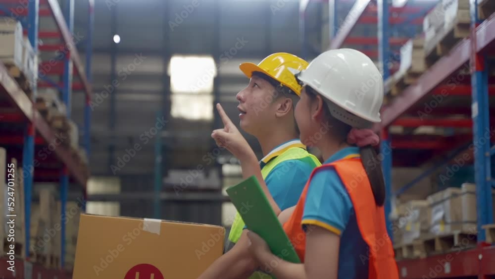 Employees at a large warehouse where two legs are kept, an Asian man and a woman checking and counting the items on the shelves inside the warehouse. The man was like a warehouse. Employees at a large warehouse where two legs are kept, an Asian man and a woman checking and counting the items on the shelves inside the warehouse. The man was like a warehouse.
