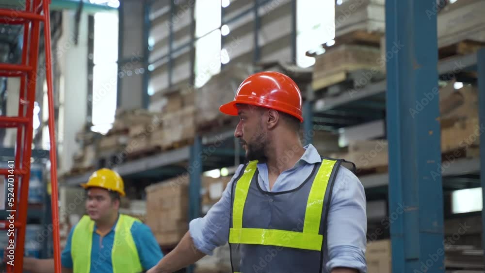 4K, The factory manager works in the Warehouse. A large warehouse is guiding employees to write ladders for climbing to inspect goods and shelves by guiding. wearing safety helmet 4K, The factory manager works in the Warehouse. A large warehouse is guiding employees to write ladders for climbing to inspect goods and shelves by guiding. wearing safety helmet