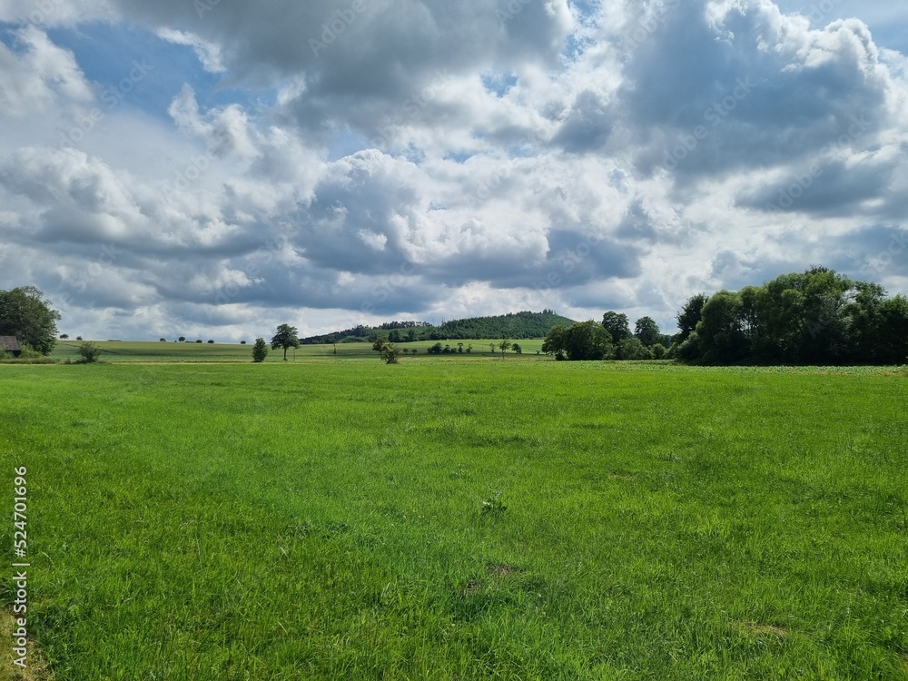 green land under a painting of clouds: landscape near Amecke, Sauerland, North Rhine-Westphalia, Germany