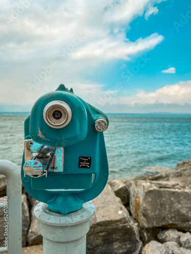 Vintage Style Coin-Operated Telescope Overlooking the Turquoise Lake Waters