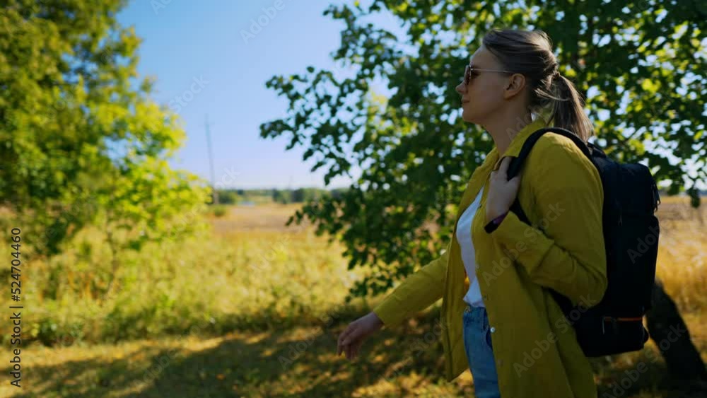 Woman tourist with backpack walking in the countryside. Woman tourist with backpack walking in the countryside.