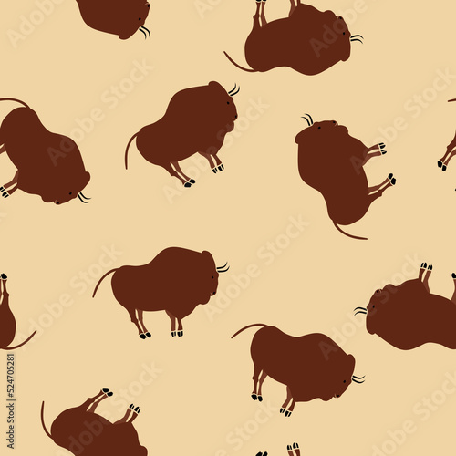 Seamless pattern with bison rock paintings on beige background. Ancient art.