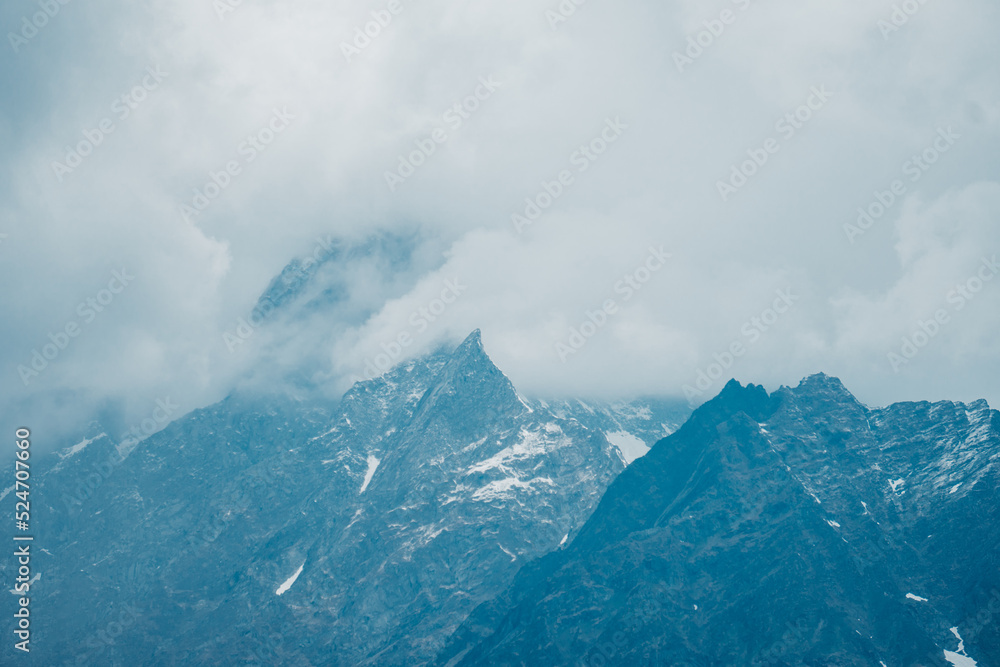 Mt. Hanuman Tibba peak Covered with dark stormy clouds as seen from Bhrigu Lake Trek in Manali, Himachal Pradesh. Himalayan mountains. Clouds covering mountains. winter background