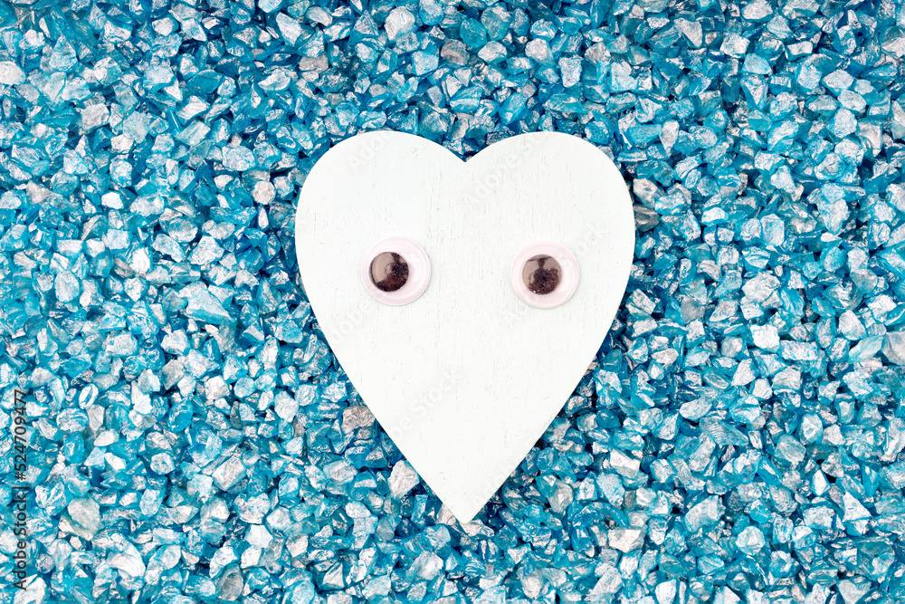 Obraz premium heart symbol with toy eyes on a background of blue stones