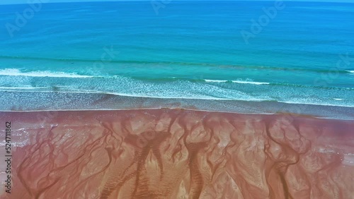Beauty in nature. Graphic sand shapes of stream meeting ocean waves