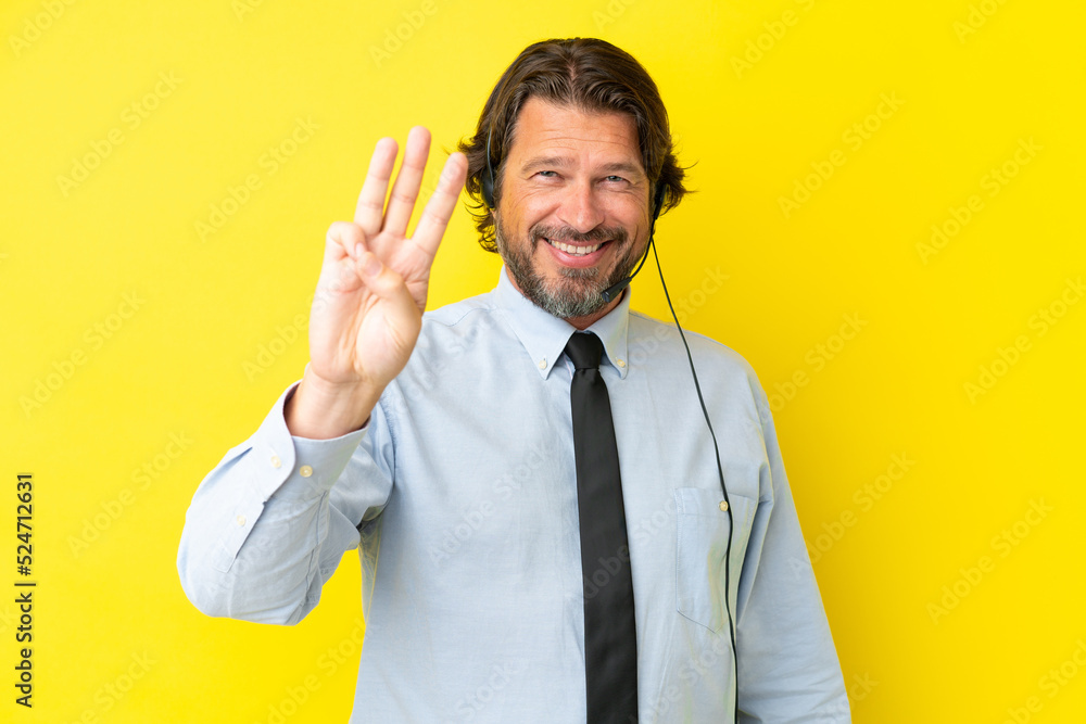 Telemarketer dutch man working with a headset isolated on yellow background happy and counting three with fingers Telemarketer dutch man working with a headset isolated on yellow background happy and counting three with fingers