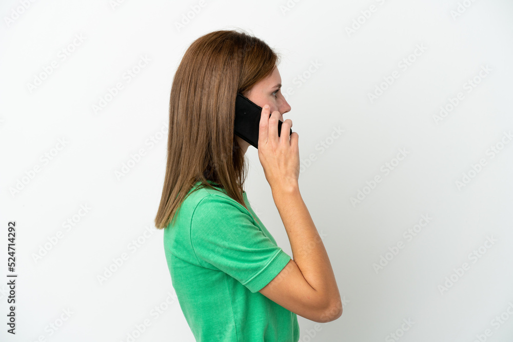 Young English woman isolated on white background keeping a conversation with the mobile phone with someone Young English woman isolated on white background keeping a conversation with the mobile phone with someone