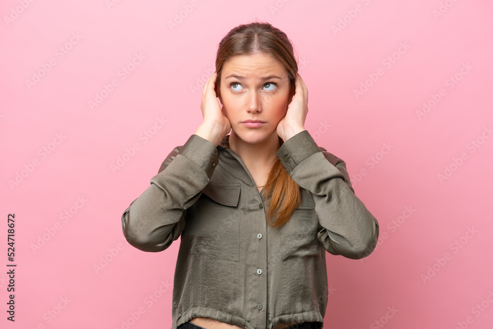 Young caucasian woman isolated on pink background frustrated and covering ears Young caucasian woman isolated on pink background frustrated and covering ears