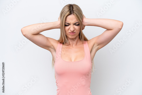 Pretty blonde woman isolated on white background frustrated and covering ears