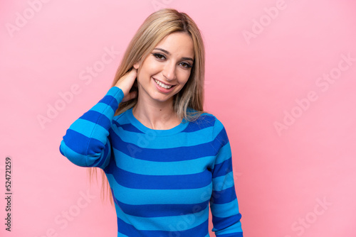 Pretty blonde woman isolated on pink background laughing © luismolinero