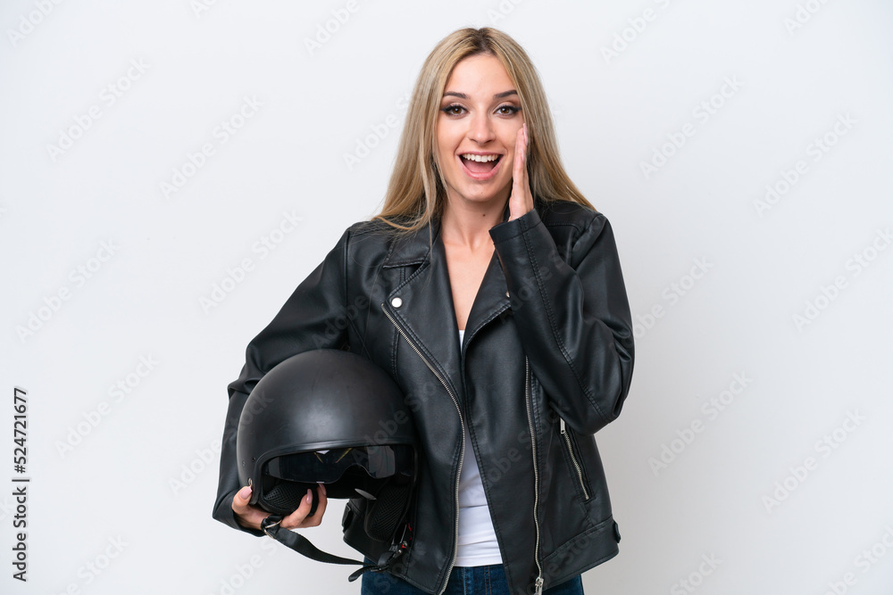 Pretty blonde woman with a motorcycle helmet isolated on white background with surprise and shocked facial expression Pretty blonde woman with a motorcycle helmet isolated on white background with surprise and shocked facial expression
