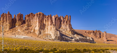 Jagged ignimbrite cliffs and rock formations in the volcanic active area in the vicinity of the salt lake Salar de Tara on the high altitude plateau of the Altiplano, Chile