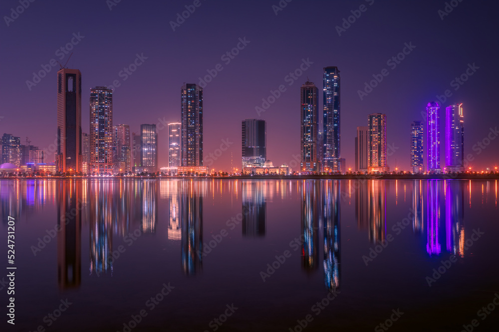 The tallest towers in the Emirates and their reflection on the lakes at night, Dubai, Sharjah