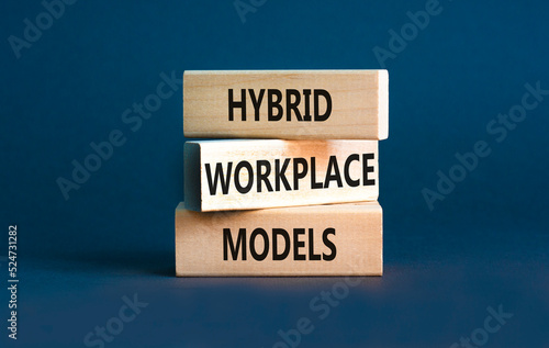 Hybrid workplace models symbol. Concept words Hybrid workplace models on wooden blocks. Beautiful grey table grey background. Business hybrid workplace models quote concept. Copy space photo